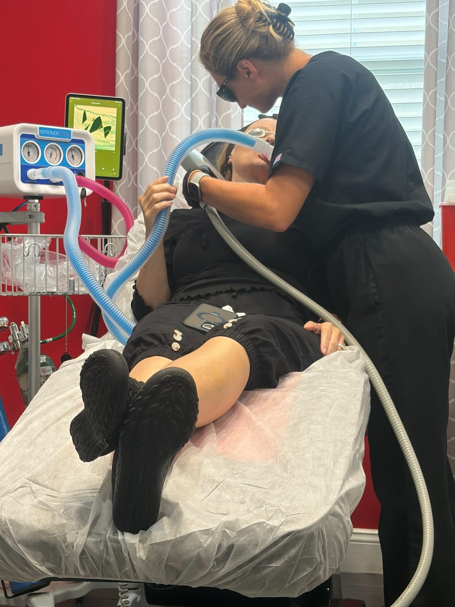 A Padgett Medical Center provider treating a patient, both wearing protective eyewear
