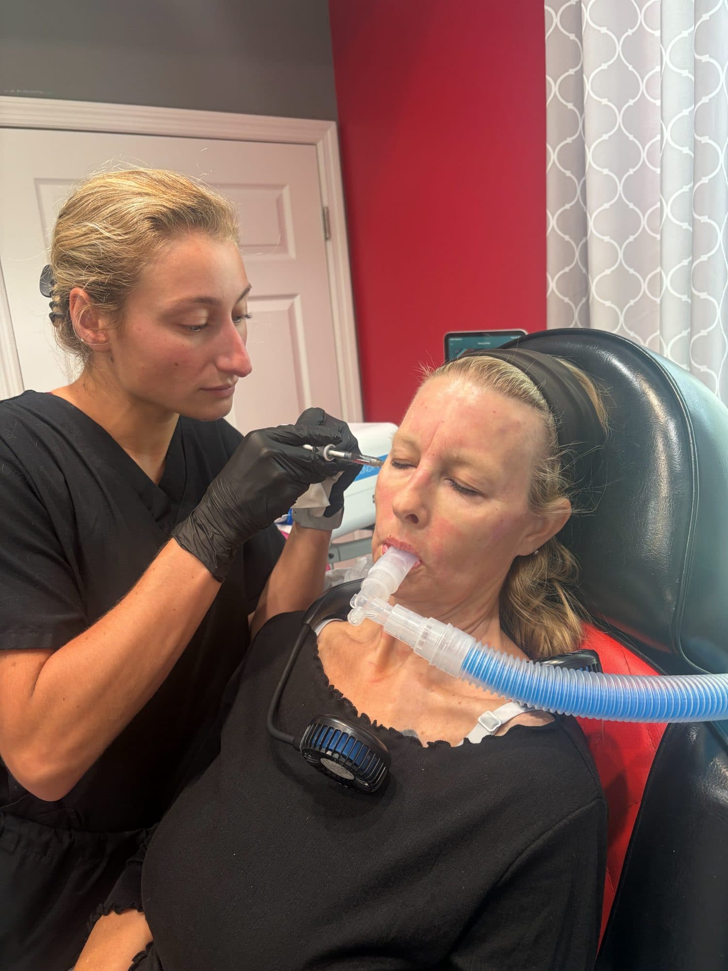 A patient using nitrous oxide for comfort during a facial treatment at Padgett Medical Center