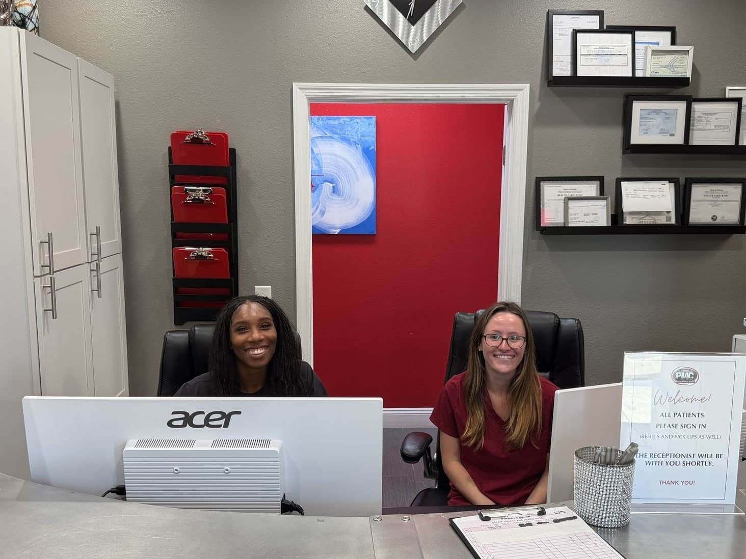 Two Padgett Medical Center team members at the front desk in Tampa